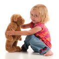Goldilocks girl playing with bear