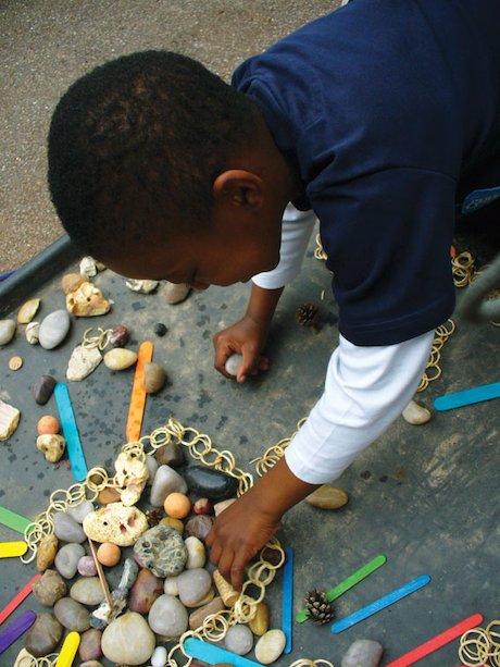 Child using found objects Child using found objects