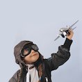 Girl playing with toy aeroplane