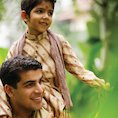 Boy and father celebrating Diwali