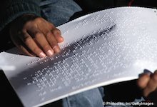 child reading braille