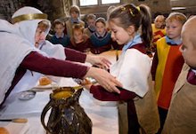School children experiencing castle banquet