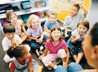 happy children listening to teacher reading story