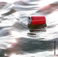 Drinks can floating on water