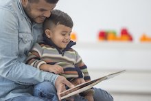 Man reading to a young boy Man reading to a young boy