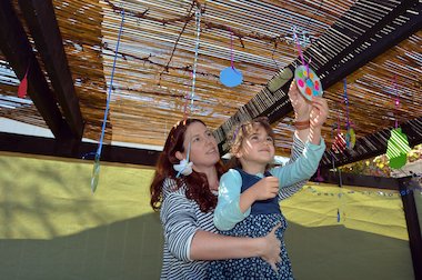 child celebrating Sukkot child celebrating Sukkot