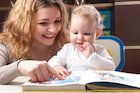adult reading to baby