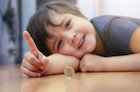 Child playing with pound coin