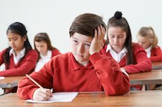 Boy in classroom looking confused Boy in classroom looking confused