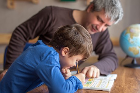 Man helping boy with maths Man helping boy with maths