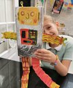 Young girl making a robot model