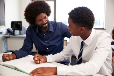 A teacher helping a student in the classroom.