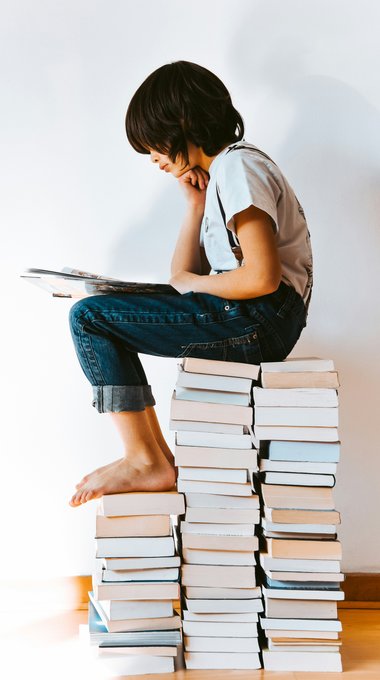 Child reading on a stack of books Child reading on a stack of books